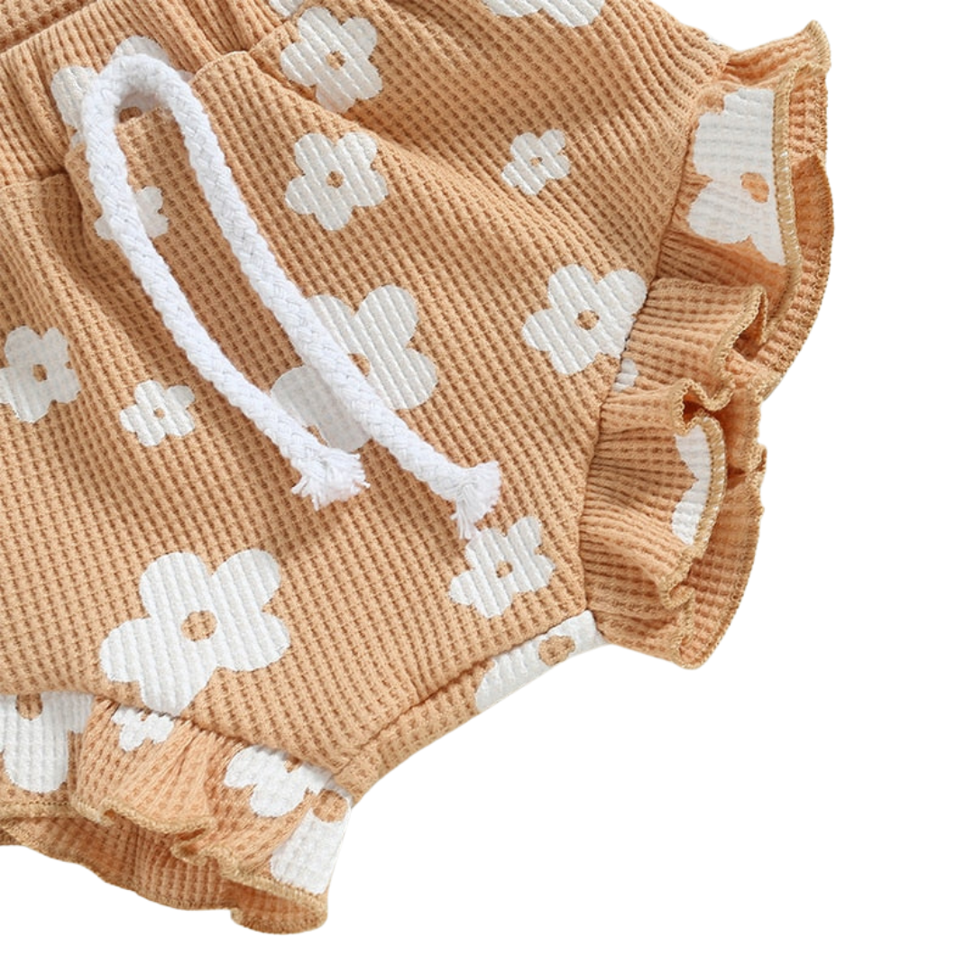 Daisy Romper and Bummies Set - Beige Baby outfit set including a white sleeveless bodysuit with pink floral pattern, matching shorts, and a bow headband