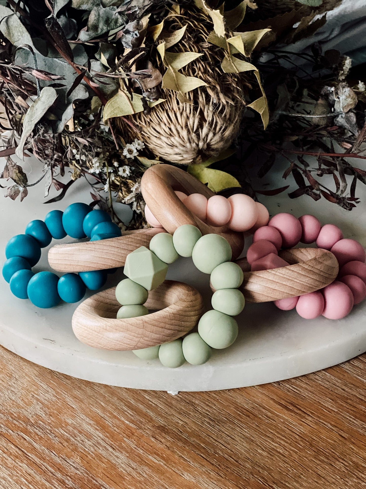 Silicone and Beechwood Teething Ring - Classic Teether Toy Silicone and Beech Wood Teething Ring - Silicone and beech wood teethers are the best of both worlds when it comes to soothing your little ones teething woes. Soft BPA free, food grade silicone will help soothe sore gums while natural beech wood will provide relief as well as assisting with teeth to emerge. Safe and practical teething toy. Ready made, ready to ship.