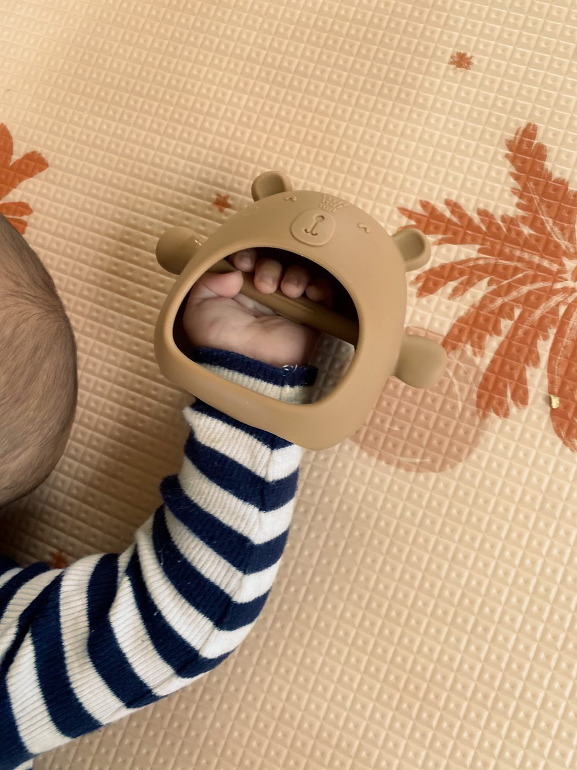 Teething Mitten Glove Silicone Bear - Teether Mitt Baby constantly chewing on hands, can't quite grasp objects just yet? These teething mitten gloves are perfect as a first Teether. Made from all silicone, they are lightweight, easy to keep clean and perfect to soothe those gums. Slip over baby's hand for them to grasp the internal bar and watch baby self soothe those teething woes.  The Little bear ears and arms are textured on the back giving that extra soothing effect.