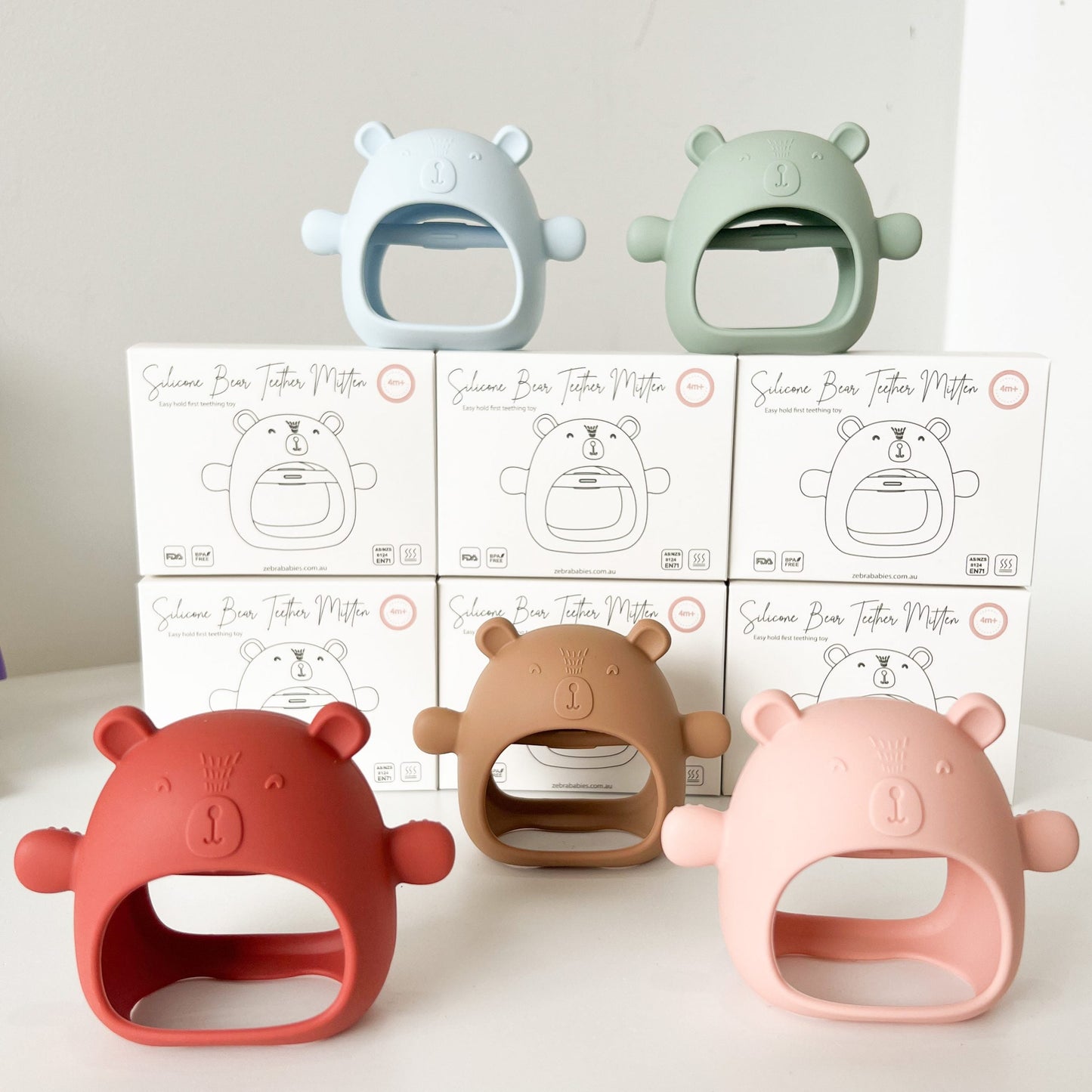 Teething Mitten Glove Dummy Clip Silicone Bear - Teether Mitt Baby constantly chewing on hands, can't quite grasp objects just yet? These teething mitten gloves are perfect as a first Teether. Made from all silicone, they are lightweight, easy to keep clean and perfect to soothe those gums. Slip over baby's hand for them to grasp the internal bar and watch baby self soothe those teething woes. The Little bear ears and arms are textured on the back giving that extra soothing effect.