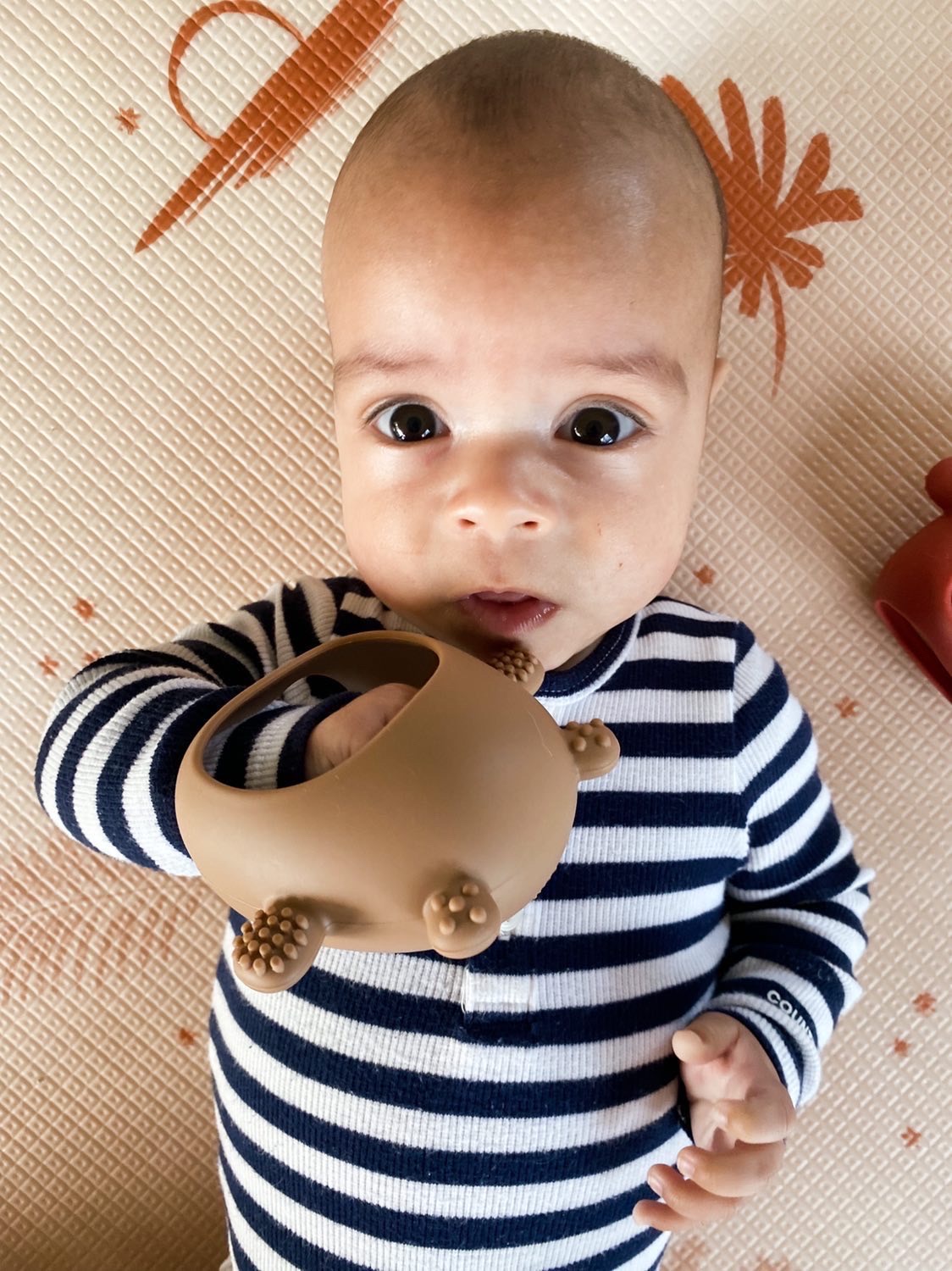 Teething Mitten Glove Silicone Bear - Teether Mitt Baby constantly chewing on hands, can't quite grasp objects just yet? These teething mitten gloves are perfect as a first Teether. Made from all silicone, they are lightweight, easy to keep clean and perfect to soothe those gums. Slip over baby's hand for them to grasp the internal bar and watch baby self soothe those teething woes. The Little bear ears and arms are textured on the back giving that extra soothing effect.