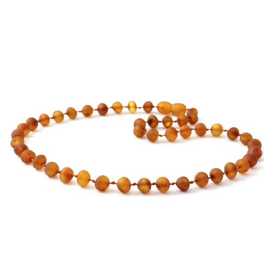 Amber Necklace Cognac Raw | 32cm Our Amber necklaces imported directly from Lithuania, the home of Baltic Amber and the Baltic Sea, where they are beautiful handmade. Baltic Amber necklaces help with teething symptoms as well as looking great. Amber beads are a great natural solution to assist your child through the misery of teething!