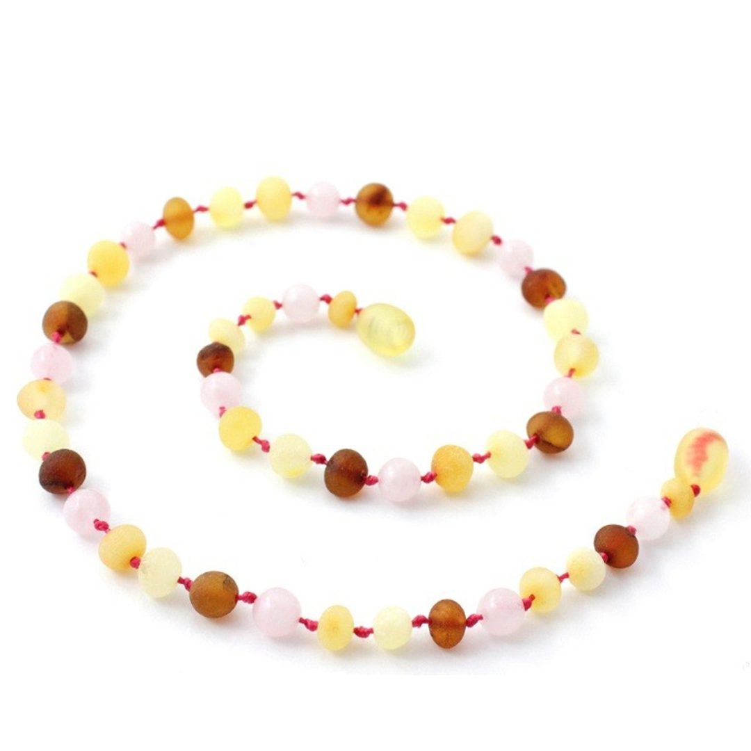 Amber Necklace Multi amber raw and Rose Quartz Baby 32cm Our Amber necklaces imported directly from Lithuania, the home of Baltic Amber and the Baltic Sea, where they are beautiful handmade. Baltic Amber necklaces help with teething symptoms as well as looking great.