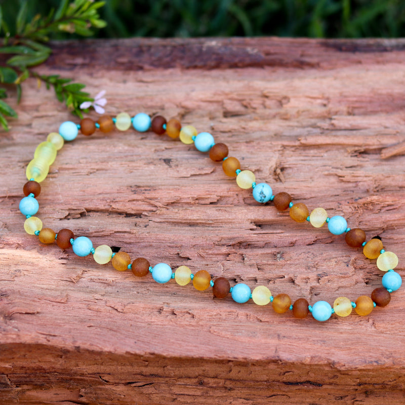 Amber Necklace Multi amber raw and Turquoise Baby 32cm Our Amber necklaces imported directly from Lithuania, the home of Baltic Amber and the Baltic Sea, where they are beautiful handmade. Baltic Amber necklaces help with teething symptoms as well as looking great.