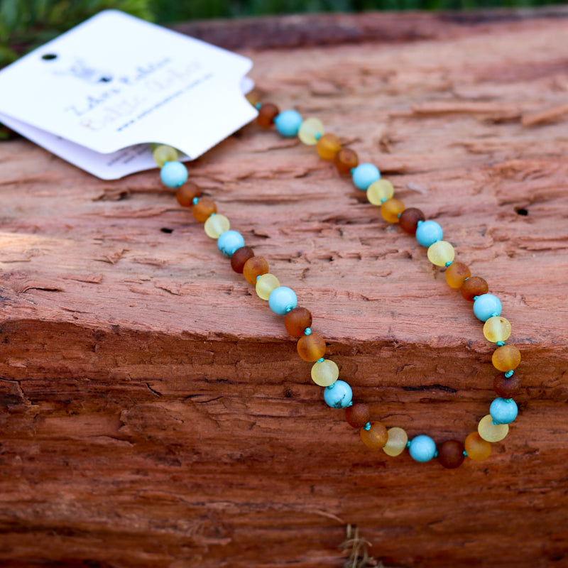 Amber Necklace Multi amber raw and Turquoise Baby 32cm Our Amber necklaces imported directly from Lithuania, the home of Baltic Amber and the Baltic Sea, where they are beautiful handmade. Baltic Amber necklaces help with teething symptoms as well as looking great.