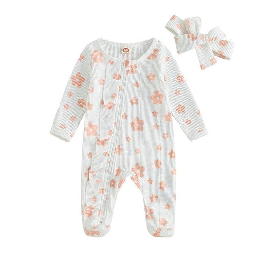 Daisy Zip Up Jumpsuit - White Introducing the enchanting Daisy Zip Up Jumpsuit for your precious baby girl – where comfort meets whimsical style! Crafted from soft, breathable fabric, this jumpsuit is designed with your little one in mind, ensuring comfort whether she’s playing, napping, or embarking on daily adventures. The cotton material makes it perfect for any season, providing a cozy warmth during cooler days and a breezy feel when the sun decides to shine.