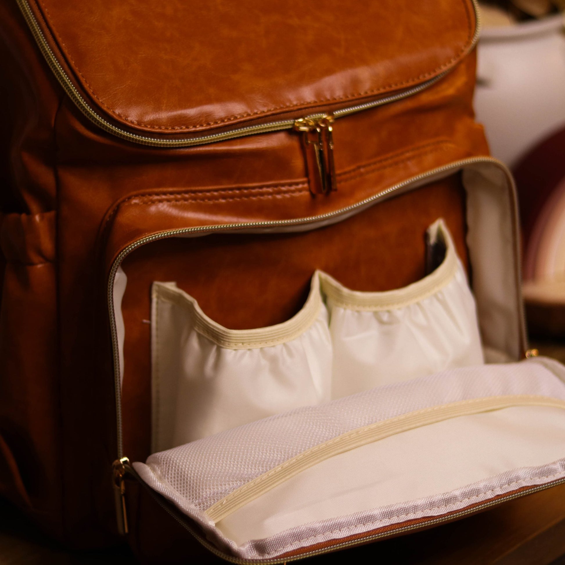 Faux Leather Nappy Bag Backpack - Luxe Tan Brown Our Faux Brown Leather Nappy Bag adds a sophisticated look to an everyday essential, stylish, functionality for everyday use. Nappy bag backpacks are an essential part of the babies haul when leaving the house – A Must have! An Amazing quality, so soft to touch, multi functional backpack, perfect for busy parents.