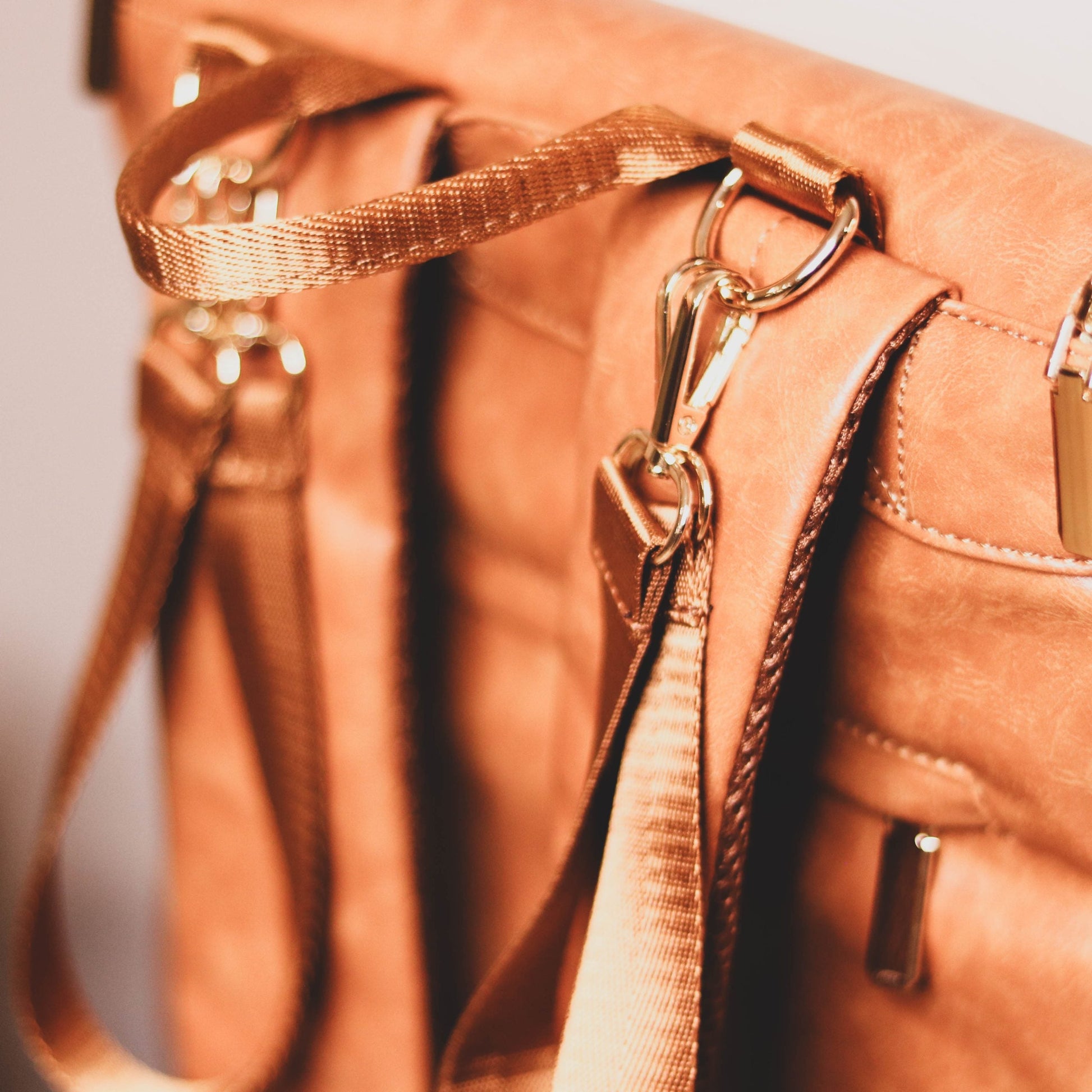 Faux Leather Nappy Bag Backpack - Luxe Tan Brown Our Faux Brown Leather Nappy Bag adds a sophisticated look to an everyday essential, stylish, functionality for everyday use. Nappy bag backpacks are an essential part of the babies haul when leaving the house – A Must have! An Amazing quality, so soft to touch, multi functional backpack, perfect for busy parents.