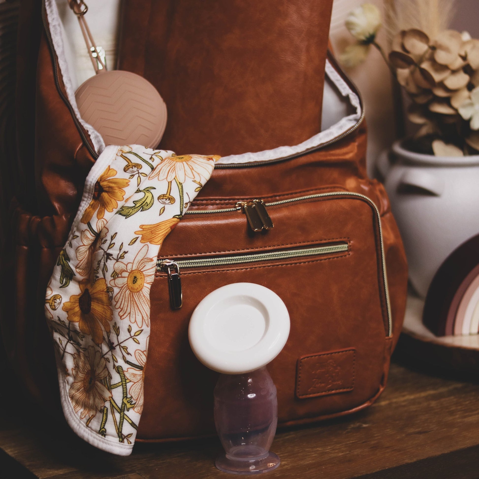 Faux Leather Nappy Bag Backpack - Luxe Tan Brown Our Faux Brown Leather Nappy Bag adds a sophisticated look to an everyday essential, stylish, functionality for everyday use. Nappy bag backpacks are an essential part of the babies haul when leaving the house – A Must have! An Amazing quality, so soft to touch, multi functional backpack, perfect for busy parents.