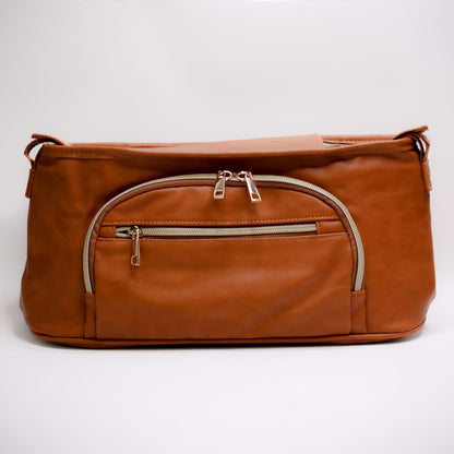 Pram Caddy Pram Caddy Organiser Faux Leather - Tan Pram caddy organisers keep everything you need close at hand, whilst keeping you hands-free. Our Pram Caddy is made from high-quality faux leather