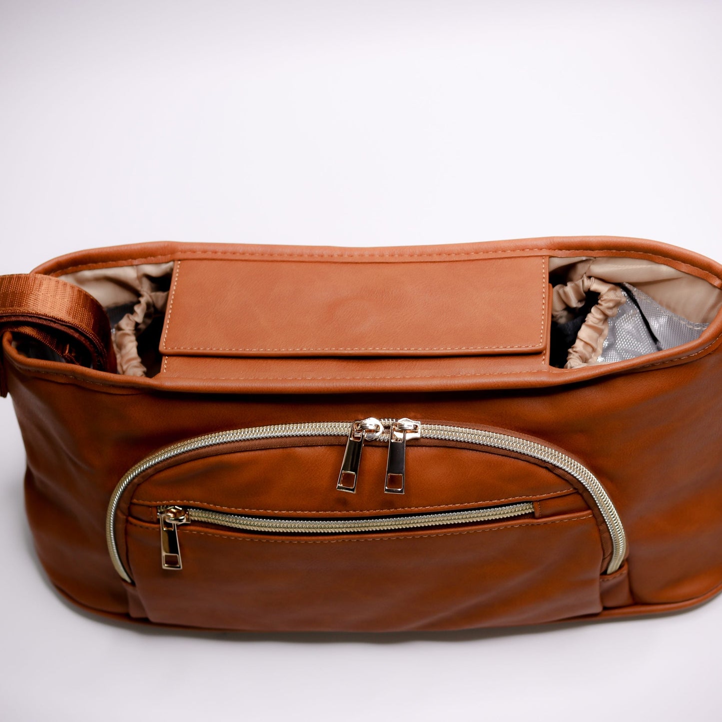 Pram Caddy Pram Caddy Organiser Faux Leather - Tan Pram caddy organisers keep everything you need close at hand, whilst keeping you hands-free. Our Pram Caddy is made from high quality faux leather