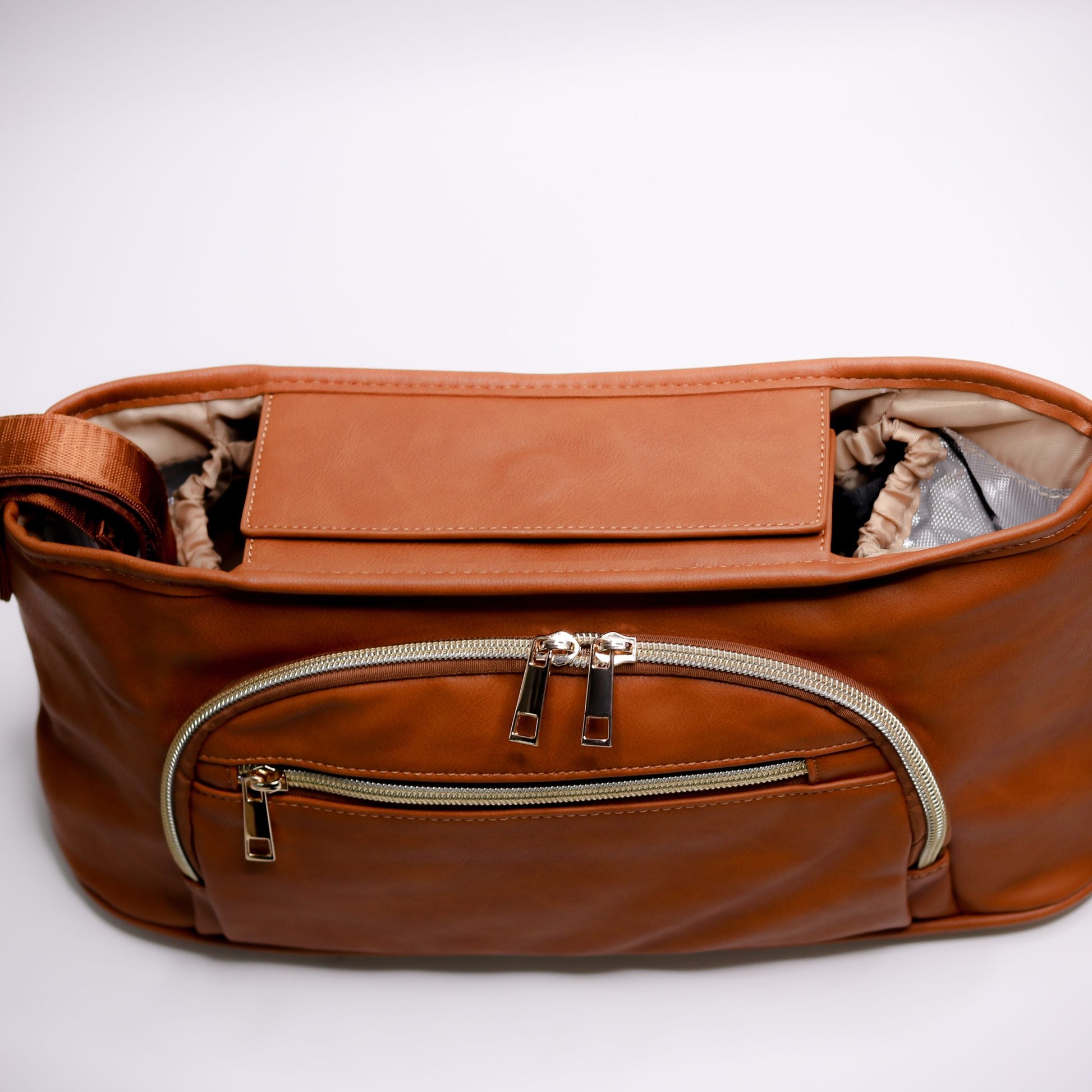 Pram Caddy Pram Caddy Organiser Faux Leather - Tan Pram caddy organisers keep everything you need close at hand, whilst keeping you hands-free. Our Pram Caddy is made from high quality faux leather