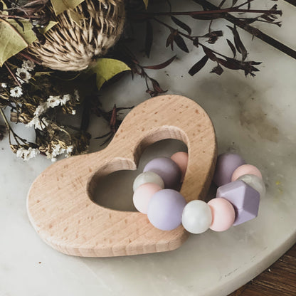 Silicone and Wood Heart Teething Ring Teether Silicone and wood teether-  The best of both worlds. Soft BPA free food grade silicone will help soothe sore gums while natural beech wood will provide relief as well as assisting with teeth to emerge. Safe fun and practical teething. Our teething toys come beautifully packaged making them the perfect gift. Our Teething toys are ready made and ready to ship asap. Your little one will love our unique designs and colour combinations. 