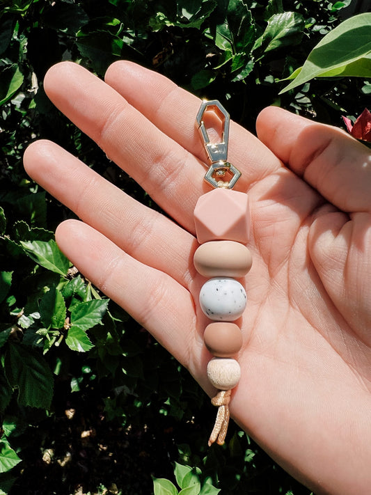Silicone Bead Keychain - Peaches and Cream Help find your keys a little easier in the bottom of your bag or add some extra bling to your nappy bag. Whatever the case our keychains are super cute. Handmade in Townsville QLD, from silicone beads wood beads. Our keychain clasps are high quality and tarnish resistant.  Our silicone bead keychains are not a toy or a teether and are for decoration purposes only. Approx. length is 12-13cm. To clean just wipe over with a damp cloth.