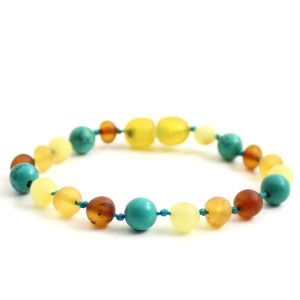 Amber Bracelet Multi Raw & Turquoise | Baby 14cm Our Amber bracelets imported directly from Lithuania, the home of Baltic Amber and the Baltic Sea, where they are beautiful handmade. Baltic Amber bracelets help with teething symptoms as well as looking great on baby. Amber beads are a great natural solution to assist your child through the misery of teething! These are not designed to be chewed or mouthed in any way. It's believed that when worn against the skin, heated by body temperature, the beads release natural oil (succinic acid) that are absorbed, soothing aches and pains. They have been used through the centuries for healing, pain relief and to boost the bodies immune system. Zebra Babies necklaces are lightweight and comfortable for your child to wear and they look great. Each Amber purchase comes beautifully packaged with a storage pouch. Inside the tags are all the care and safety information also. We think of the environment when packaging our amber and try to reduce plastic packaging. Baltic Amber and Gemstones. Length: 14cm approx. It’s always recommended to measure before your purchase.  Check out our FAQ All Our necklaces and Bracelets are beaded and knotted Safety Information Amber beads are designed to be worn and not chewed. The necklaces should only be worn under supervision and not when your child is sleeping. Each bracelet has been carefully handcrafted with your babies safety in mind. Knots between each bead mean that if the necklace is broken, only one bead will come off. A special clasp will release the necklace if too much pressure is applied. Each bead is carefully rounded and polished to be comfortable against your child's skin. Amber resin is not cold to touch and should not annoy your child when first worn (gemstone will be slightly cooler than room temperature) . We offer a 6 month warranty on all Amber Jewellery. Each Amber piece is individual and colours can change slightly. Please note each piece is handmade and sizes may vary slightly. Raw vs Polished? Our raw baltic amber is unpolished amber and is the true form of Baltic amber, uses less heat when processed, and contains more succinic acid. Full amber or amber and gemstones? Amber and gemstones look amazing and are a cute addition to our necklace. Gemstones provide their own benefits also. I do recommend more amber beads over gemstones for full affections but have a general feedback that both work amazing!