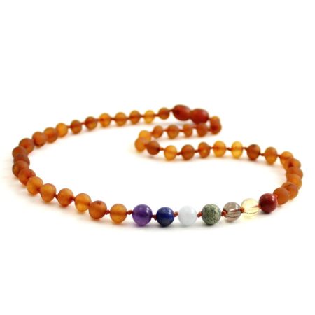 Amber Necklace Cognac Chakra | Baby 32cm Our Amber necklaces imported directly from Lithuania, the home of Baltic Amber and the Baltic Sea, where they are beautiful handmade. Baltic Amber necklaces help with teething symptoms as well as looking great. Amber beads are a great natural solution to assist your child through the misery of teething! These are not designed to be chewed or mouthed in any way. It’s believed that when worn against the skin, heated by body temperature, the beads release natural oil (succinic acid) that are absorbed, soothing aches and pains. They have been used through the centuries for healing, pain relief and to boost the bodies immune system. Zebra Babies necklaces are lightweight and comfortable for your child to wear and they look great. Baltic Amber and Gemstones - African Jade, Aquamarine, Tiger Eye, Lapis Lazuli, Citrine, Amethyst and Red Jasper Length: 32cm approx. It’s always recommended to measure before your purchase.  Check out our FAQ All Our necklaces and Bracelets are beaded and knotted Each Amber purchase comes beautifully packaged with a storage pouch. Inside the tags are all the care and safety information also. We think of the environment when packaging our amber and try to reduce plastic packaging.